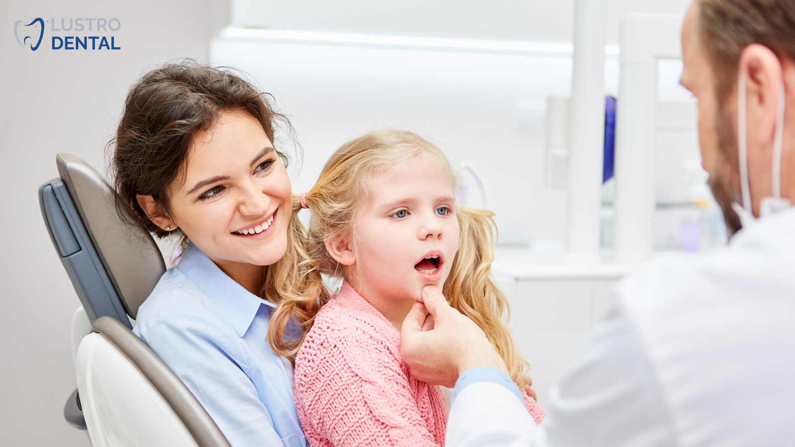 A dental hygienist demonstrates gentle cleaning techniques on a baby's teeth.